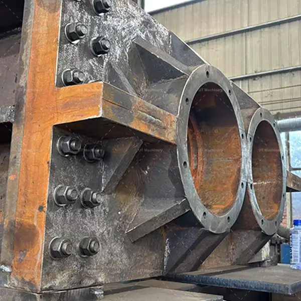 Close-up of the shaft bearing mounting and high-strength bolt connections on the shredder frame.
