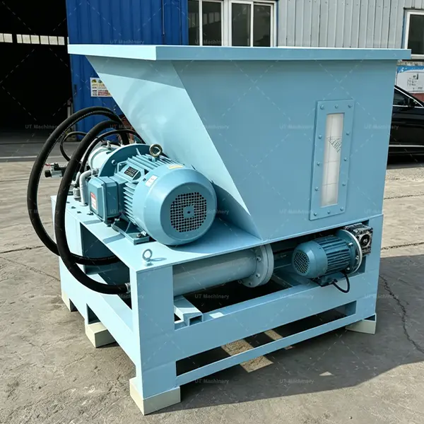 Side view of an industrial wood waste briquetting press with a large feeding hopper and integrated oil level gauge.