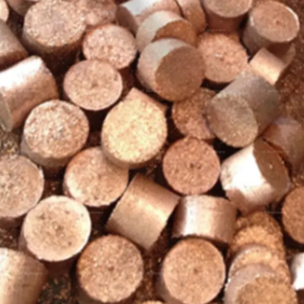 A pile of finished small cylindrical brass turnings briquettes ready for metallurgical recycling and melting.