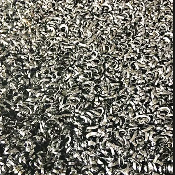 Tangled, fluffy, and springy steel turnings and machining shavings from CNC lathe centers prior to the high-density hydraulic compacting process.