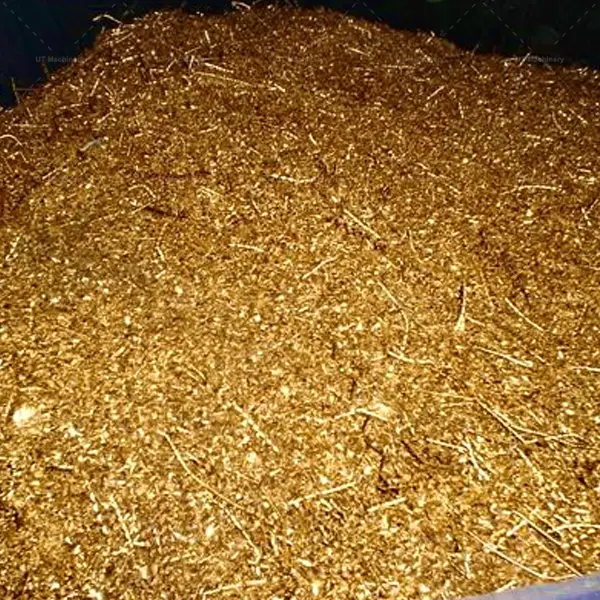Raw golden brass chips and industrial metal swarf piled up for volume reduction recycling.