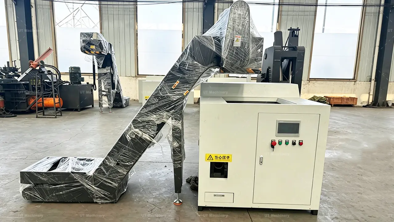 Automatic steel chips and cast iron borings briquette machine equipped with an enclosed cleated belt conveyor for dust-free scrap loading.