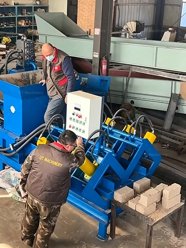 Factory operator managing the control panel of an industrial hydraulic coco peat briquette machine